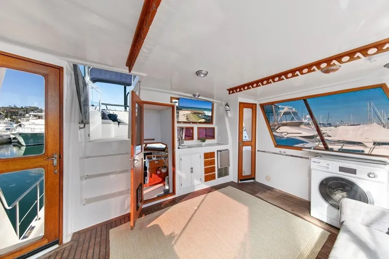 Slide: The Image of 1989 Lien Hwa Vitesse Yachtfisher interior with wood accents and marina view. - 34