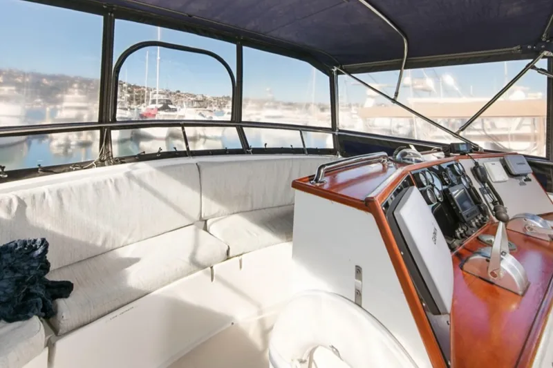 Slide: The Image of 1989 Lien Hwa Vitesse Yachtfisher interior with helm and seating area, docked at marina. - 36