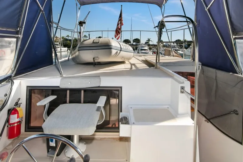 Slide: The Image of 1989 Lien Hwa Vitesse Yachtfisher helm with seating, canopy, and inflatable boat on deck. - 37