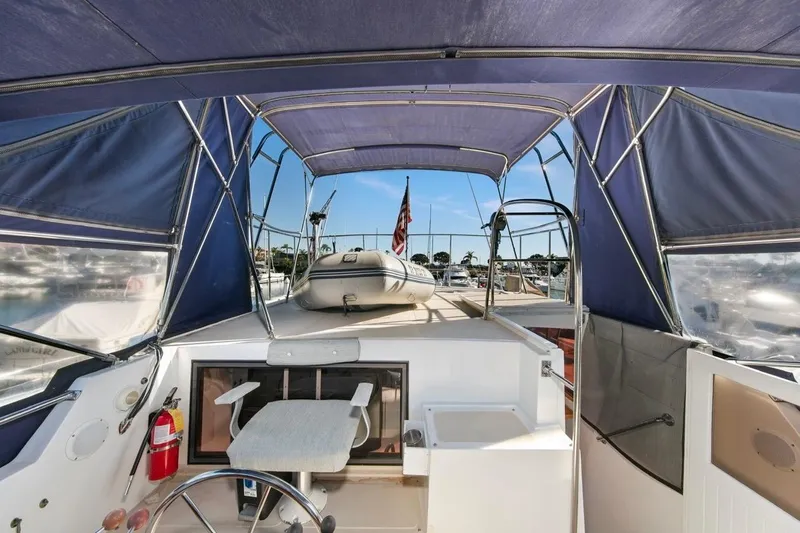 Slide: The Image of 1989 Lien Hwa Vitesse Yachtfisher interior with canopy, steering wheel, and docked view. - 38