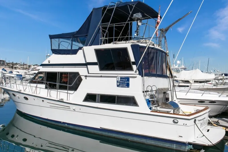 Slide: The Image of 1989 Lien Hwa Vitesse Yachtfisher docked in a marina under clear blue skies. - 4