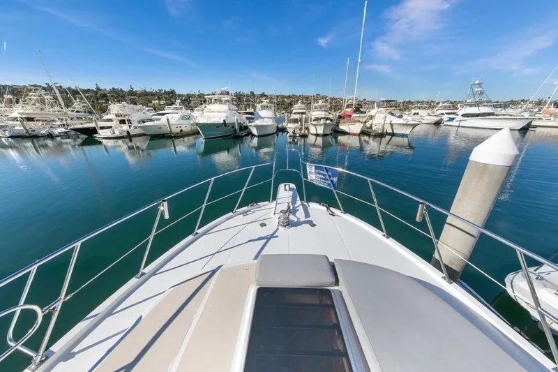 Slide: The Image of 1989 Lien Hwa Vitesse Yachtfisher docked in a marina under clear blue skies. - 43