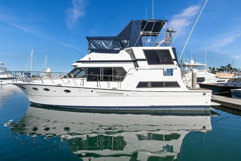 Slide: The Image of 1989 Lien Hwa Vitesse Yachtfisher docked in a marina under clear blue skies. - 50