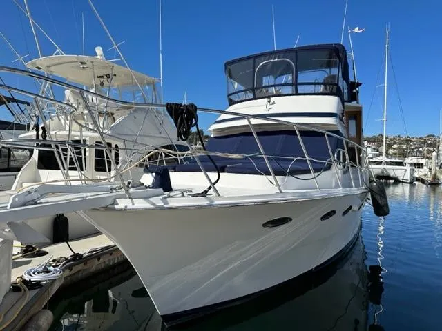 Slide: The Image of 1989 Lien Hwa Vitesse yacht docked in marina, featuring sleek design and spacious deck. - 6