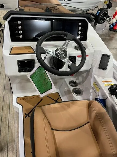 Slide: The Image of 2025 Veranda VX27DCRC boat dashboard with modern controls and tan seating. - 10