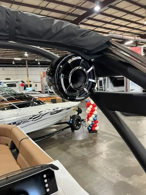 Slide: The Image of 2025 Veranda VX27DCRC boat with sleek speaker system in a showroom. - 12