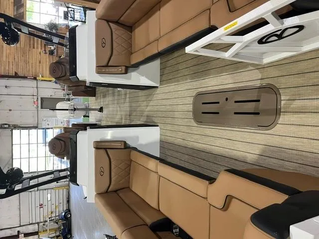 Slide: The Image of 2025 Veranda VX27DCRC interior with tan seating and wood-style flooring in a showroom. - 4
