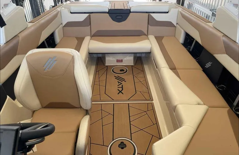 Slide: The Image of 2024 ATX Surf Boats 24 Type-S interior with tan and white seating, modern design. - 11