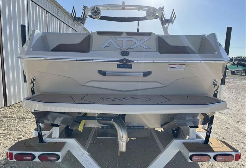 Slide: The Image of 2024 ATX Surf Boats 24 Type-S on trailer, rear view, outdoor setting. - 4