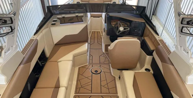 Slide: The Image of 2024 ATX Surf Boats 24 Type-S interior with tan and brown seating, modern dashboard. - 7