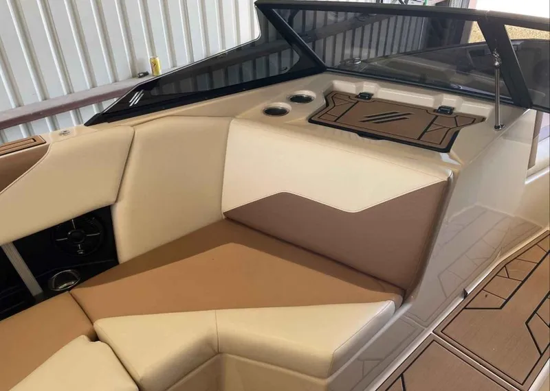 Slide: The Image of 2024 ATX Surf Boats 24 Type-S interior with beige and brown seating. - 9