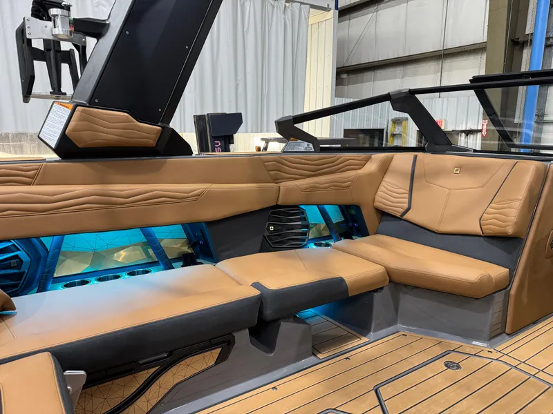 Slide: The Image of Luxurious interior of 2025 Nautique Super Air Nautique G23 boat with tan leather seating. - 11