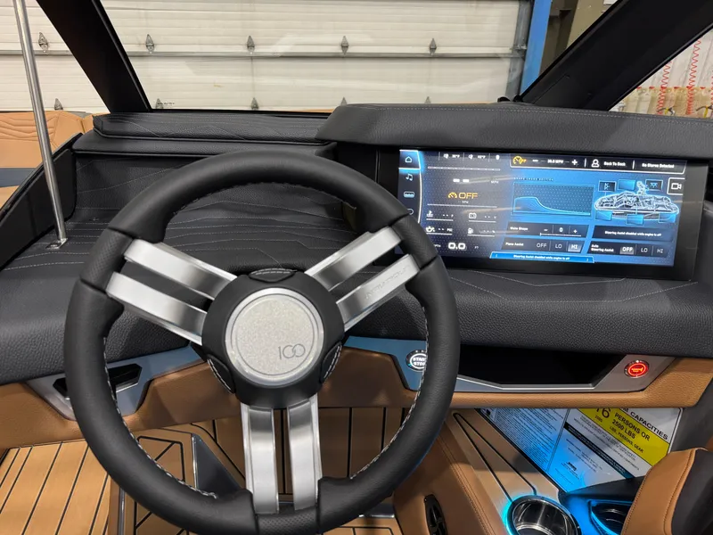 Slide: The Image of 2025 Nautique Super Air Nautique G23 dashboard with modern steering wheel and digital display. - 13