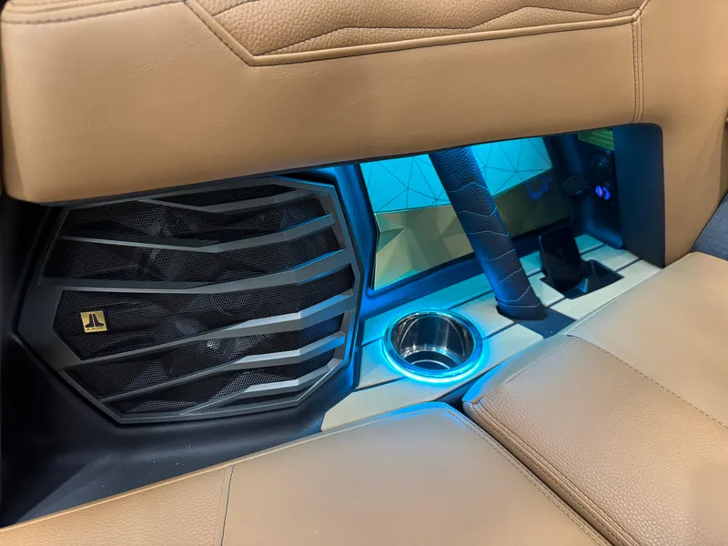 Slide: The Image of Interior of 2025 Nautique Super Air Nautique G23 with speaker and illuminated cup holder. - 15