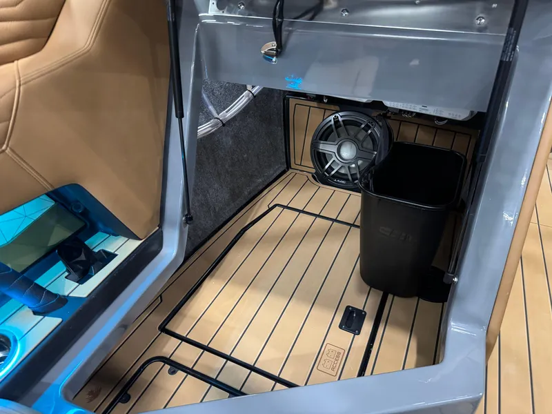Slide: The Image of 2025 Nautique Super Air Nautique G23 interior storage with speaker and tan flooring. - 17