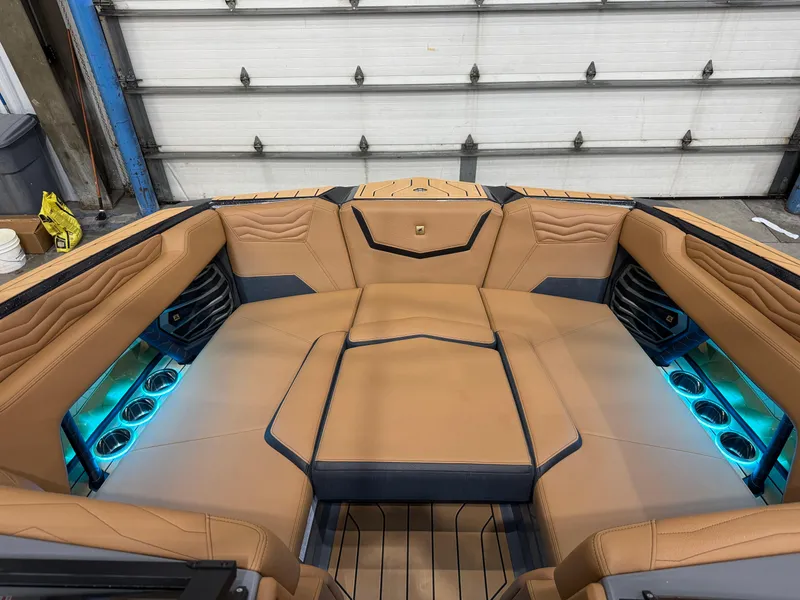 Slide: The Image of Luxurious interior of 2025 Nautique Super Air Nautique G23 boat with ambient lighting. - 20