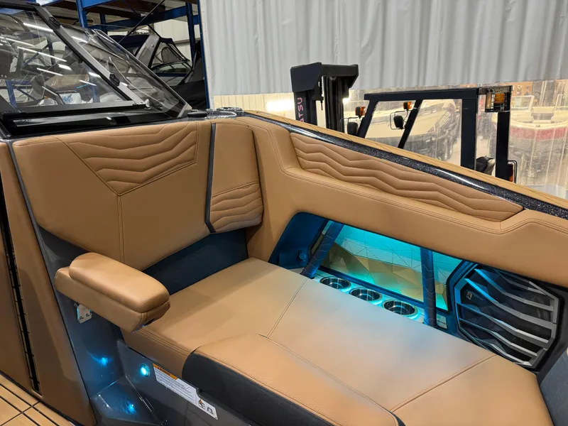 Slide: The Image of 2025 Nautique Super Air Nautique G23 interior with tan leather seating and ambient lighting. - 23
