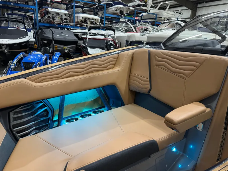Slide: The Image of Luxurious interior of 2025 Nautique Super Air Nautique G23 boat with tan leather seating. - 24