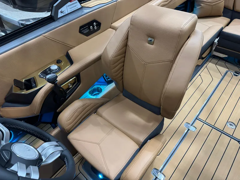 Slide: The Image of 2025 Nautique Super Air Nautique G23 interior with tan leather seating and modern controls. - 25