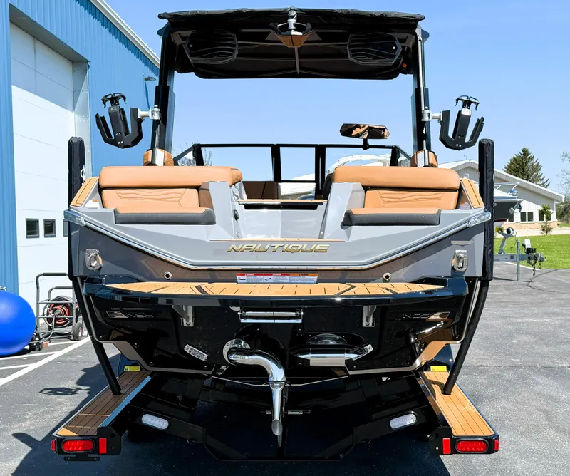 Slide: The Image of 2025 Nautique Super Air Nautique G23 boat, rear view, parked outdoors. - 3