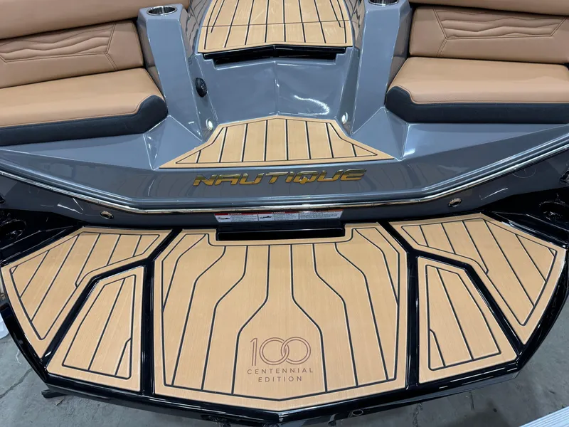 Slide: The Image of 2025 Nautique Super Air Nautique G23 Centennial Edition boat interior with custom flooring. - 5