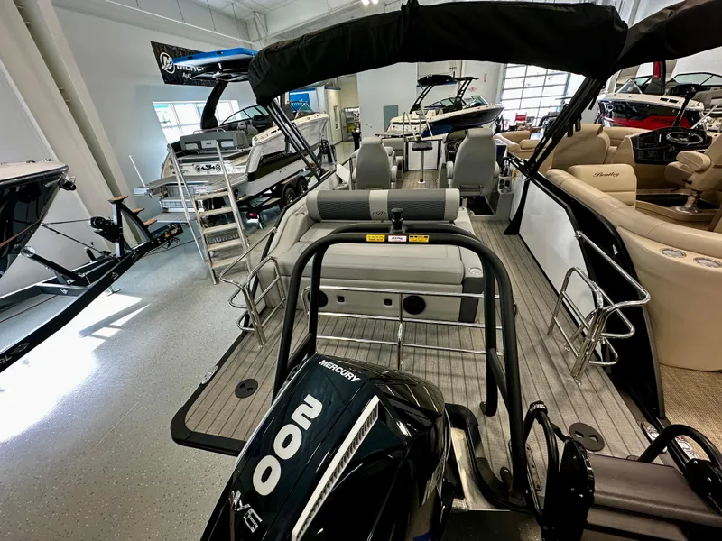 Slide: The Image of 2025 Bentley Pontoons Elite 223 Swingback in showroom, featuring a powerful Mercury 200 engine. - 5