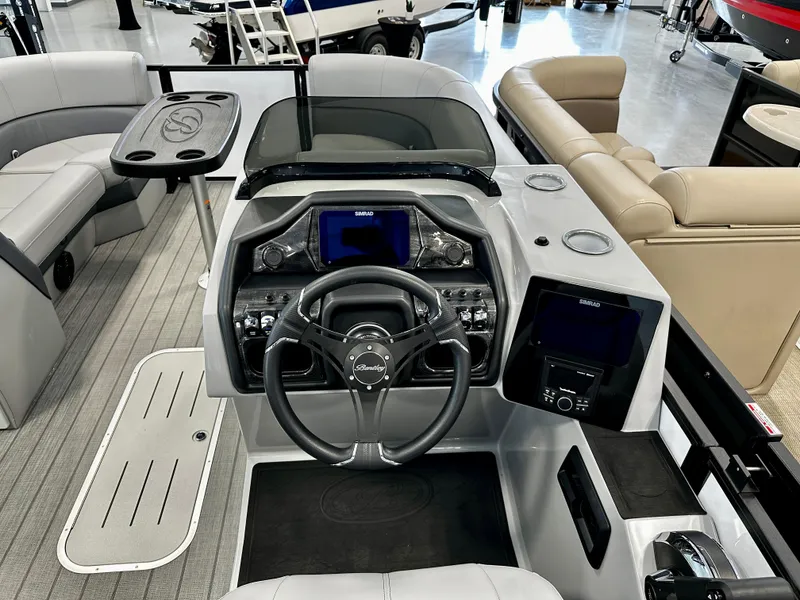 Slide: The Image of 2025 Bentley Pontoons Elite 223 Swingback dashboard with modern controls and seating. - 8