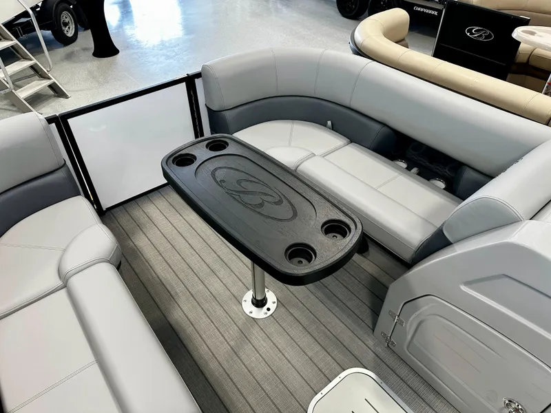 Slide: The Image of 2025 Bentley Pontoons Elite 223 Swingback interior with gray seating and central table. - 9