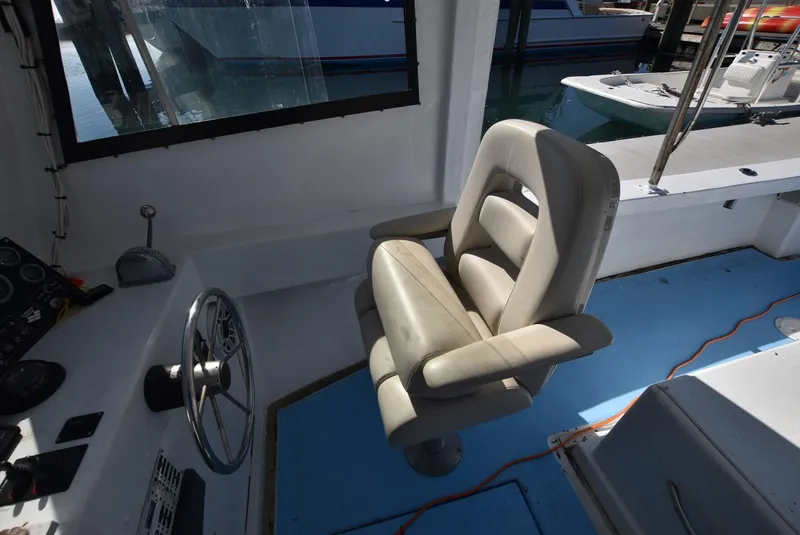 Slide: The Image of Captain's chair and steering wheel on a 2011 Custom Downeast boat. - 10