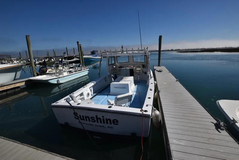 Slide: The Image of Custom 2011 Downeast boat "Sunshine" docked at a marina on a sunny day. - 2