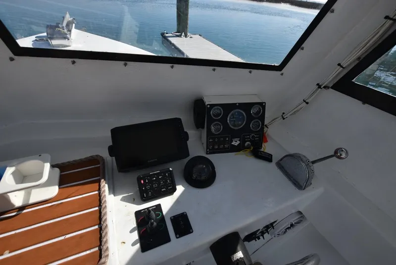 Slide: The Image of Control panel of a 2011 Custom Downeast boat with navigation equipment and gauges. - 5