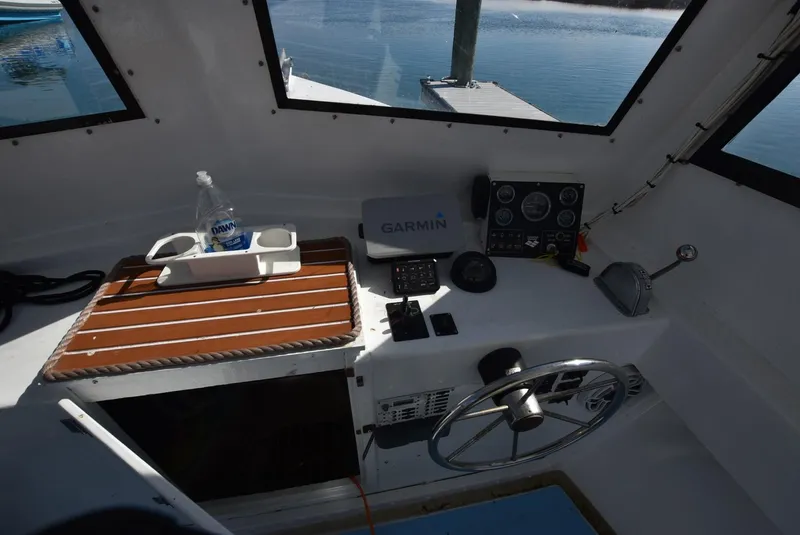 Slide: The Image of Interior of a 2011 Custom Downeast boat with Garmin navigation system and steering wheel. - 6