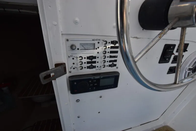 Slide: The Image of Control panel and steering wheel of a 2011 Custom Downeast boat. - 8