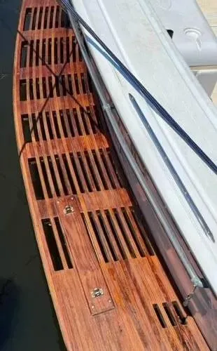 Slide: The Image of Wooden deck of a 1973 Viking 40 boat with diesel engines, showing slatted design. - 14