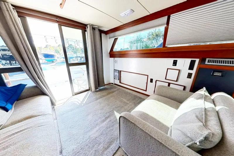 Slide: The Image of 1973 Viking 40 yacht interior, featuring modern restoration with plush seating and large windows. - 19
