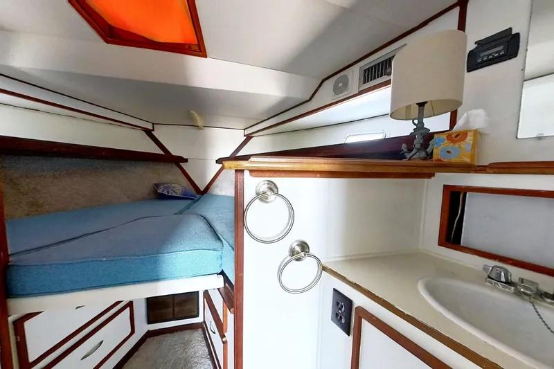 Slide: The Image of 1973 Viking 40 boat interior with restored cabin, bed, and sink area. - 29