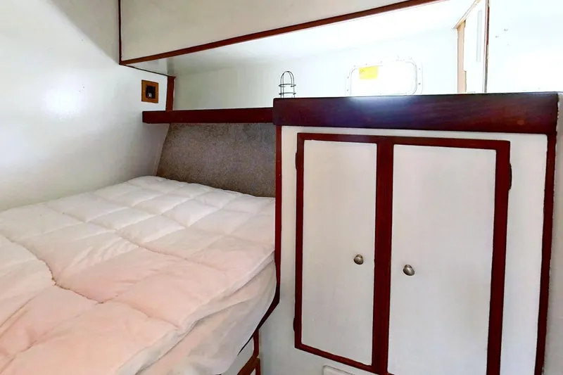 Slide: The Image of 1973 Viking 40 cabin interior with bed and storage, showcasing complete restoration. - 34