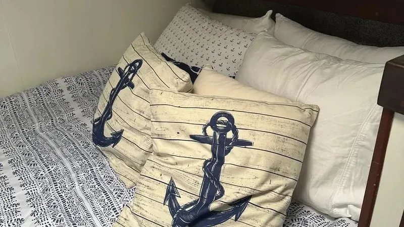 Slide: The Image of Nautical-themed bedding with anchor pillows on a Viking 40 boat, 1973 model. - 36