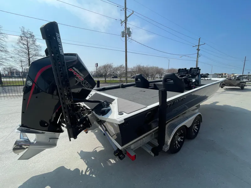 Slide: The Image of 2021 Crestliner 21 MX boat on trailer, featuring powerful outboard motor, parked outdoors. - 3
