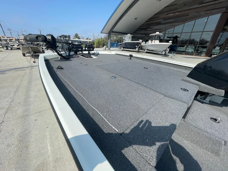 Slide: The Image of 2021 Crestliner 21 MX boat with spacious deck, parked outdoors. - 6