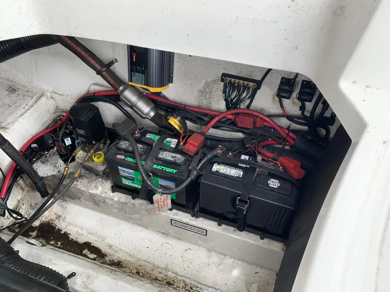 Slide: The Image of Engine compartment of a 2015 Sea Ray 250 SLX with visible batteries and wiring. - 12