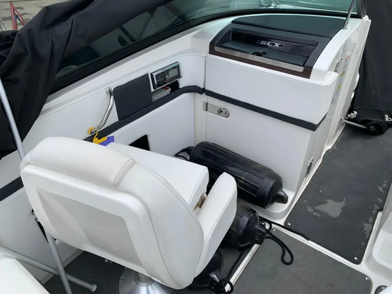 Slide: The Image of 2015 Sea Ray 250 SLX boat interior with white seating and control panel. - 3