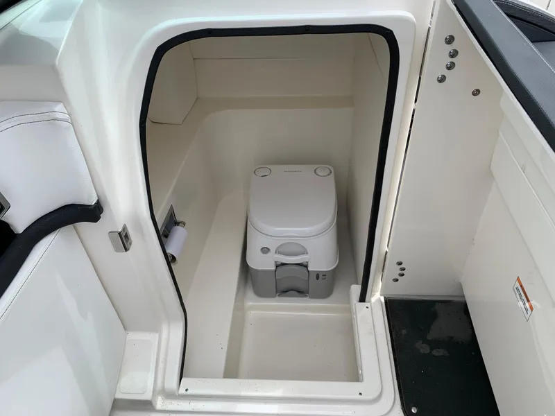 Slide: The Image of 2015 Sea Ray 250 SLX boat interior with compact marine toilet. - 5