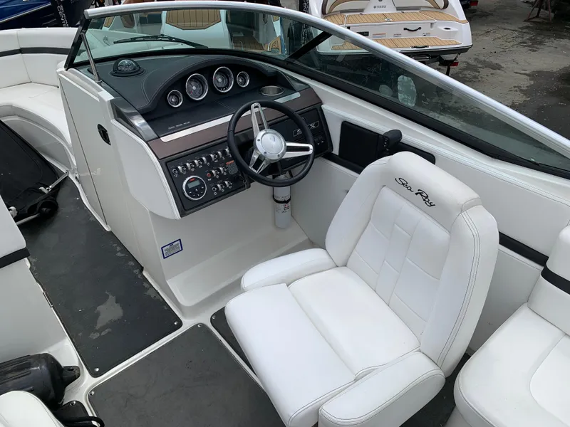 Slide: The Image of 2015 Sea Ray 250 SLX boat interior with white seating and control panel. - 6