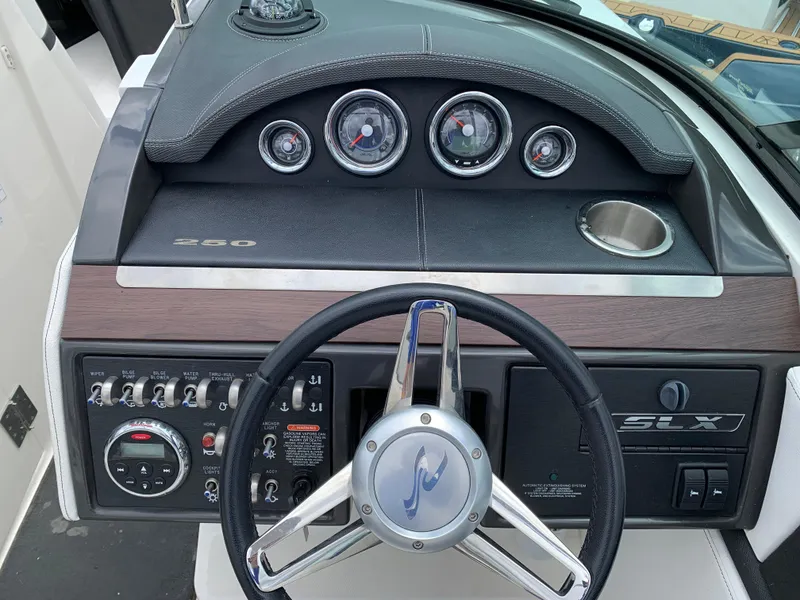 Slide: The Image of 2015 Sea Ray 250 SLX dashboard with steering wheel and instrument panel. - 7