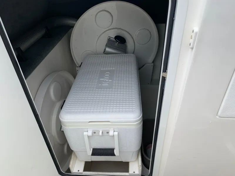 Slide: The Image of Storage compartment in a 2015 Sea Ray 250 SLX boat with a white Igloo cooler. - 9