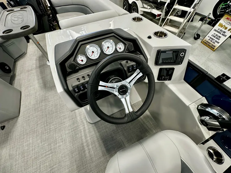 Slide: The Image of 2025 Bentley Pontoons 223 Swingback dashboard with steering wheel and gauges. - 8