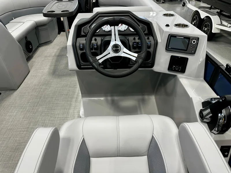 Slide: The Image of 2025 Bentley Pontoons 223 Swingback interior with steering wheel and dashboard controls. - 9
