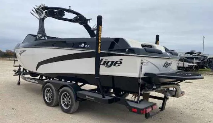 Slide: The Image of 2024 Tigé Z5 boat on trailer, sleek design, dual-axle, ready for water adventures. - 3