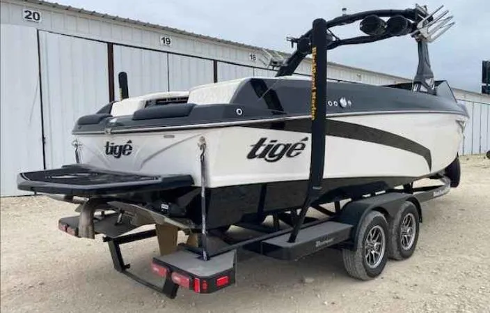 Slide: The Image of 2024 Tigé Z5 boat on trailer, parked near storage units. - 4